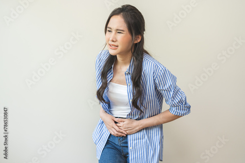 Canvas Print Flatulence asian young woman intolerance hand in stomach ache, suffer from food poisoning, abdominal pain and colon problem, gastritis or diarrhoea when at home