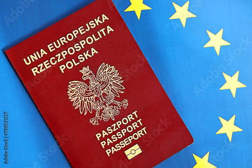 Poland passport of European Union on blue flag background close up. Tourism and citizenship concept