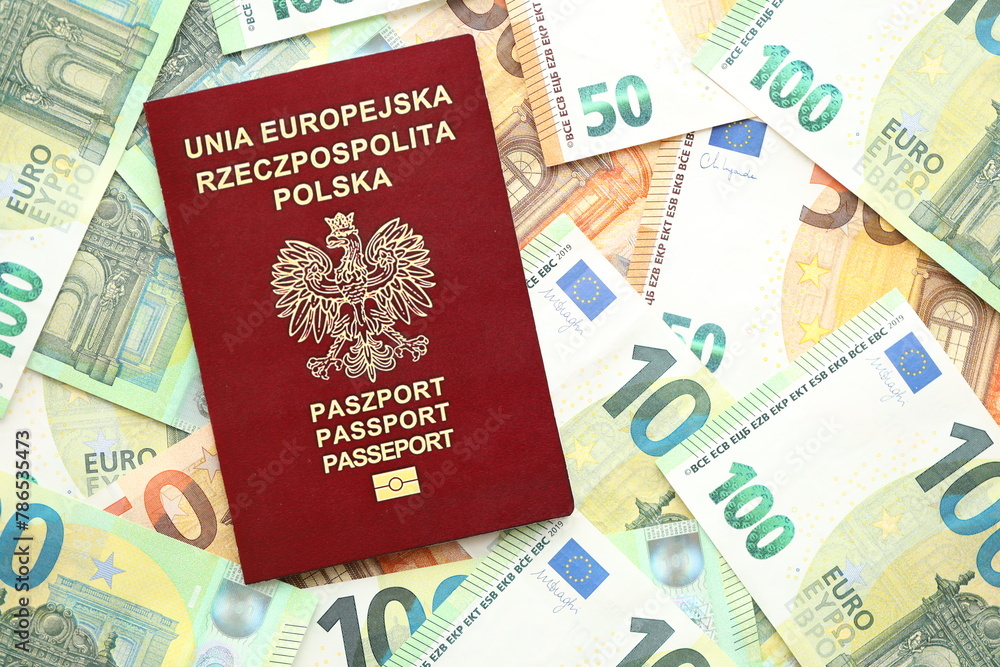 Red polish passport and big amount of european euro money bills close up Red polish passport and big amount of european euro money bills close up