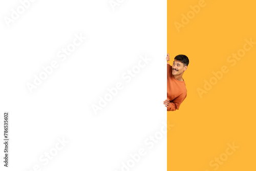 Man peeking out from behind a blank banner