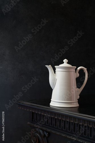 Still life with vintage white porcelain teapot