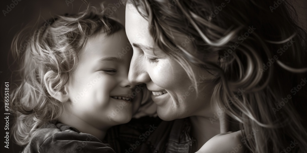 Fototapeta premium Monochrome portrait of joyful Caucasian mother and child in a loving embrace