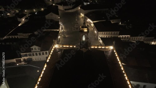 Drone descends over Museu da Inconfidência at night overlooking Praça Tiradentes photo