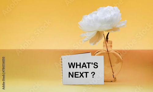 What's next, the phrase is written on a notepad, on a yellow background. Business concept, strategy, plan, planning.