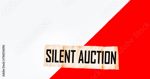 The words SILENT AUCTION consist of a note. Red and white background
