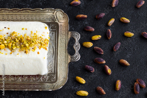 Traditional Turkish Maras Ice Cream, on a silver tray with cutlery and pistachios