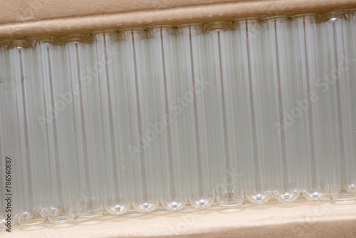 Glass test tubes stacked and sorted in a carton box
