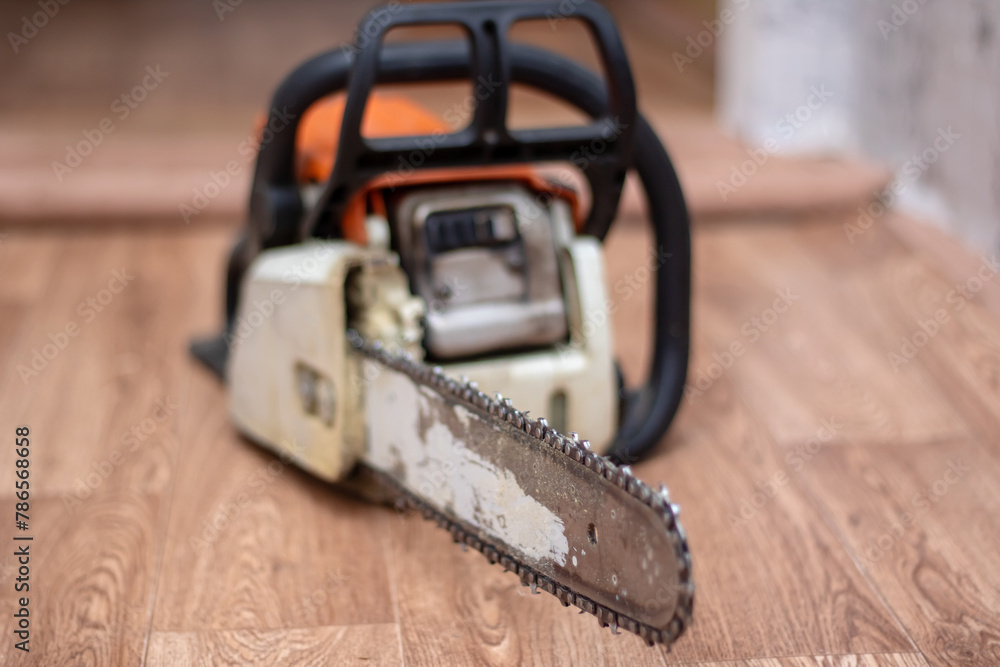 Chainsaw rests on hardwood flooring, a powerful gas machine