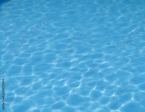 Clear blue swimming pool water with light patterns on the bottom