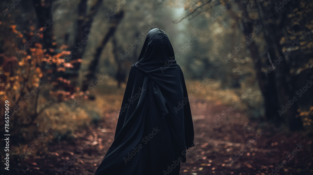 Mysterious figure enshrouded in a black cloak walks down a secluded forest path, shrouded in autumnal colors. Mysterious figure enshrouded in a black cloak walks down a secluded forest path, shrouded in autumnal colors.