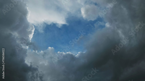 Storm clouds and hole with blue sky