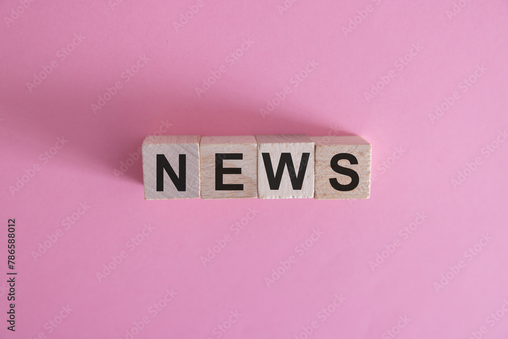 Wooden news sign on a table in an office Wooden news sign on a table in an office