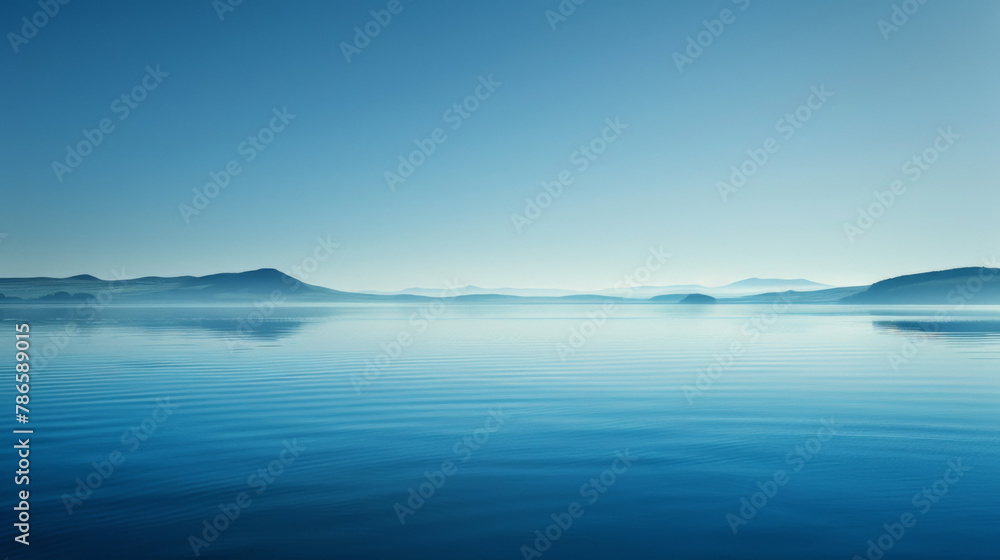 A tranquil scene featuring a nearby water surface and distant mountains, all bathed in a soothing blue hue, evoking a sense of sophistication and serenity