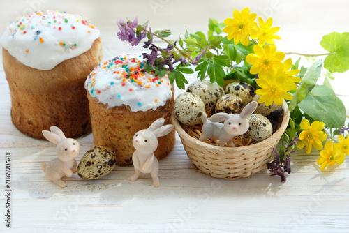 Easter holiday. Easter sweet cakes (kulich, paska), cute bunny and eggs with flowers on table close up, white background. festive composition for spring season. 