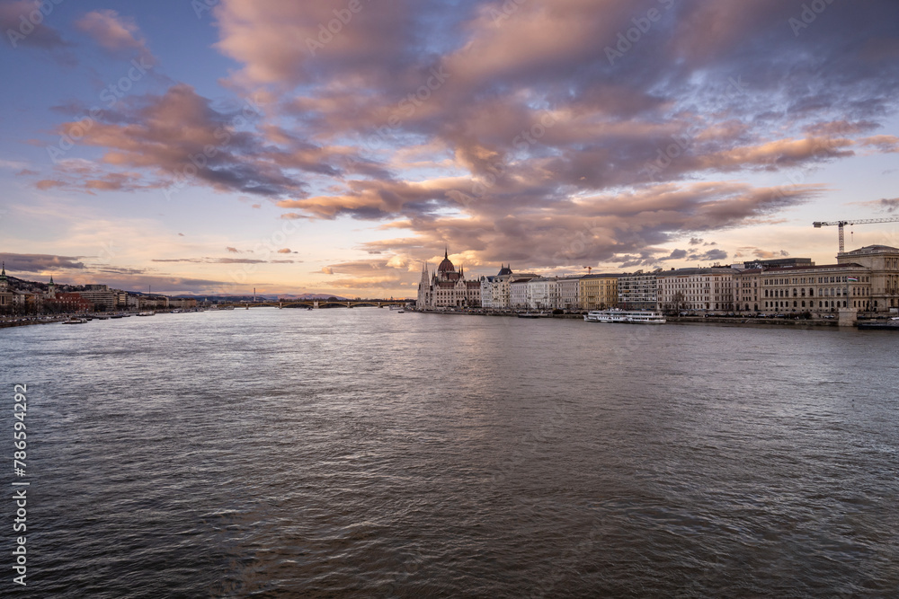 Fototapeta premium Amazing hungarian parliament building on the shore of Danube river in the city of Budapest, Hungary at sunset