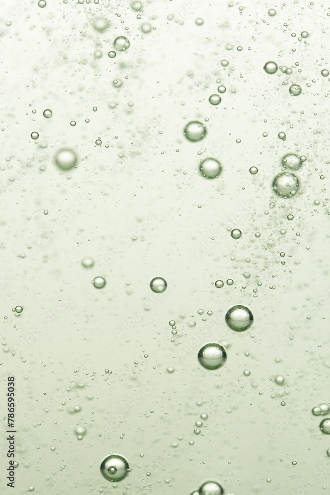 Bubbles in water on a green background. Shallow depth of field.