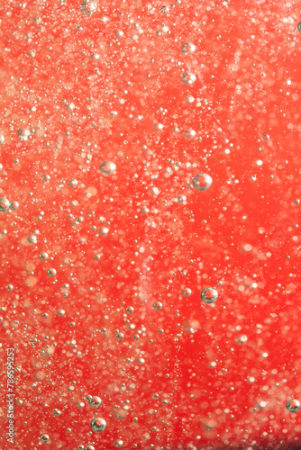 Bubbles of water on a red background closeup.