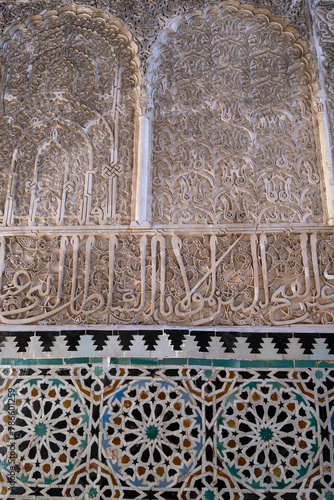 Detail of wall moroccan tilework and stucco decoration featuring Arabic calligraphy - Fez, Bou Inania Madrasa
