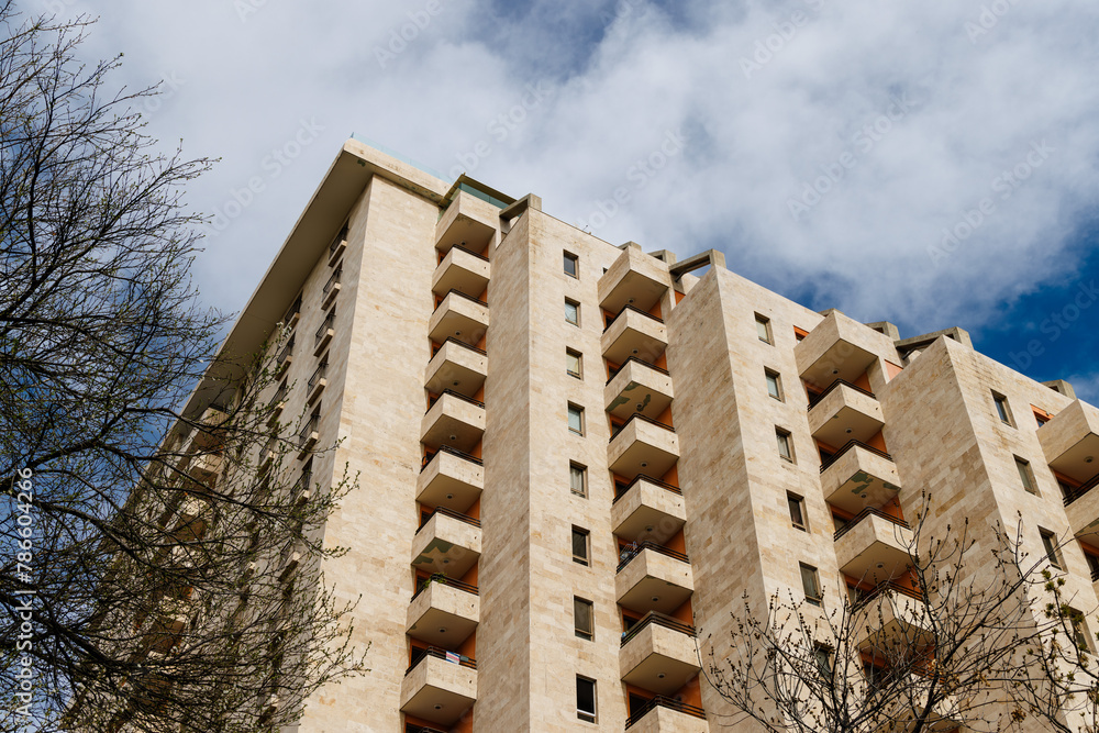 Sky-high serenity. Contemporary apartment building against partly cloudy sky.