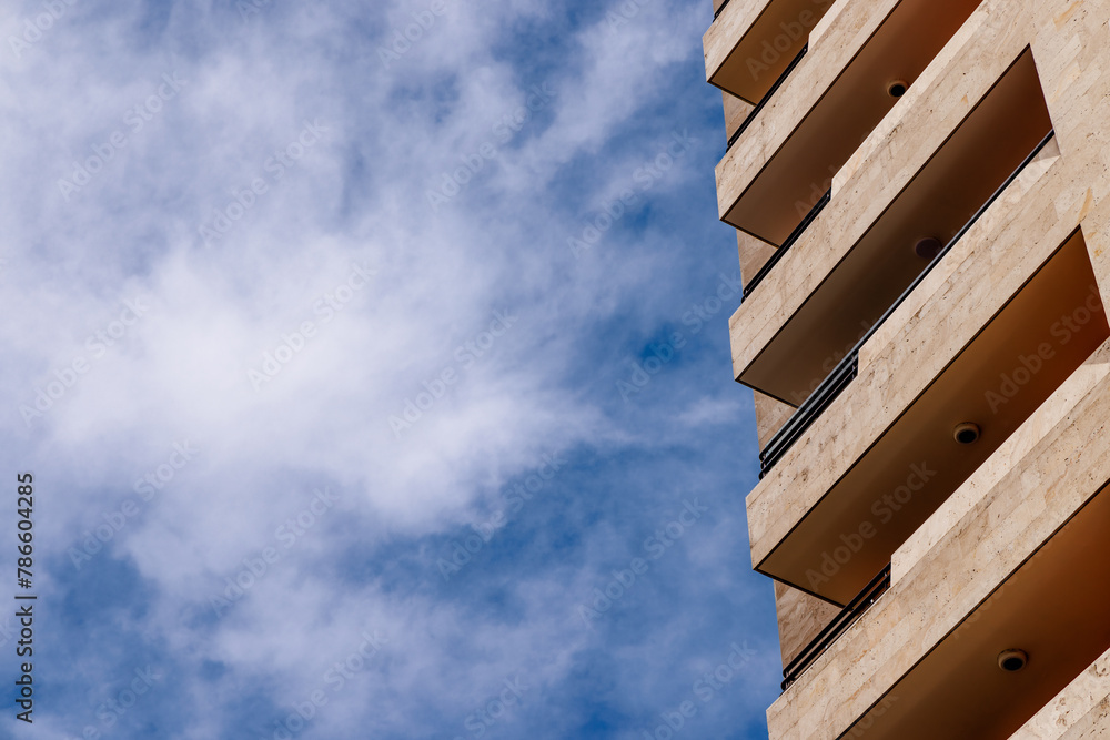 Geometric perfection. A part of modern apartment building against partly cloudy sky.