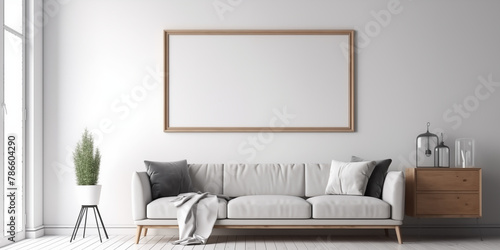 Blank picture frame mockup on white wall. White living room design. View of modern scandinavian style interior with sofa. Home staging and minimalism concept