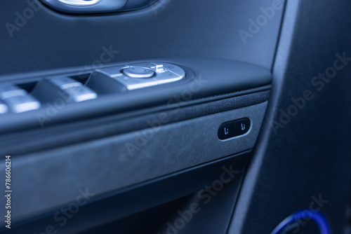Control buttons for settings and memory of the driver's seat, electric glass opening, door handle in the interior of the new luxury electric car. Driver's seat adjustment buttons photo
