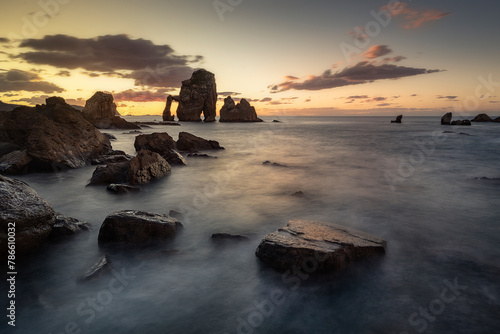 View of the Cantabrian coast at sunset in San Juan de Gaztelugatxe, Bermeo, Bizkaia, with the tide between the rock formations © patxi