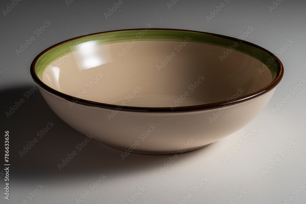 Empty rustic beige soup plate bowl with colored edge Empty rustic beige soup plate bowl with colored edge