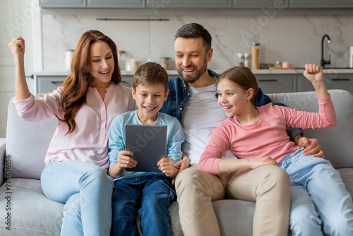 Happy family using tablet on the sofa