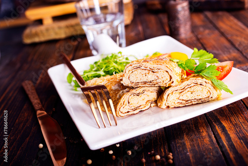 Dashimaki tamago, Japanese style rolled omelette in dish on wooden table photo