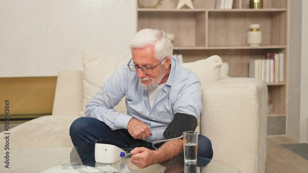 Hypertension problem in senior age. Old man measuring blood pressure with tonometer at home. Senior man have health problem making self checkup. Headache treatment of hypertension hypotension Hypertension problem in senior age. Old man measuring blood pressure with tonometer at home. Senior man have health problem making self checkup. Headache treatment of hypertension hypotension