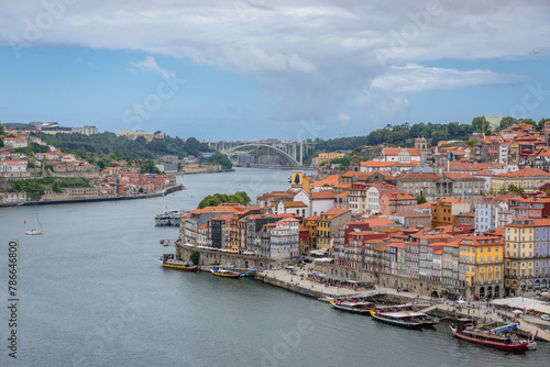 Waterfront of Douro River in Porto city, Portugal. Arrabida Bridge on background