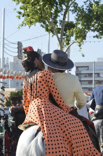 A romantic couple kissing in the world famous April fair in Seville,  Spain 