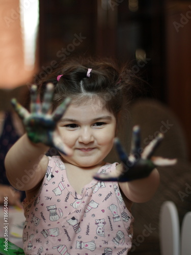 Girls playing with painting with their hands