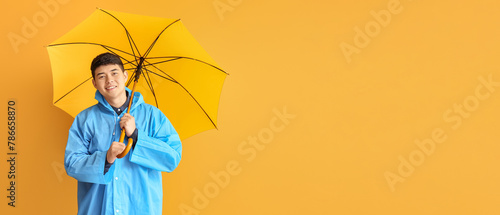 Young Asian man in raincoat...
