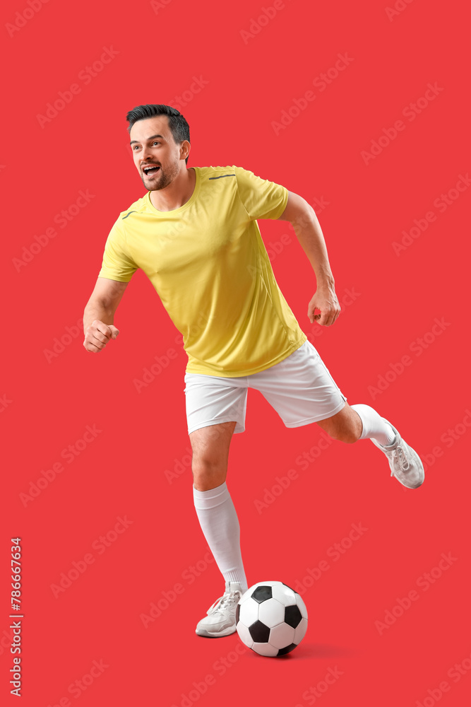 Portrait of male football player on red background