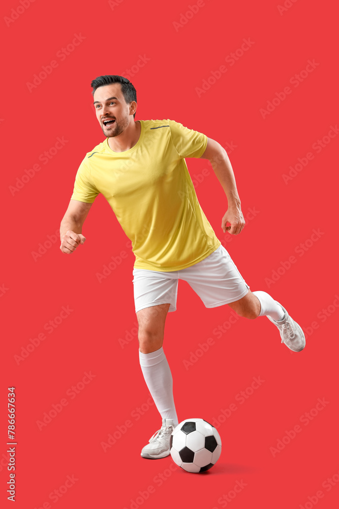Portrait of male football player on red background Portrait of male football player on red background