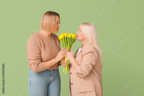 Adult woman greeting her mo...