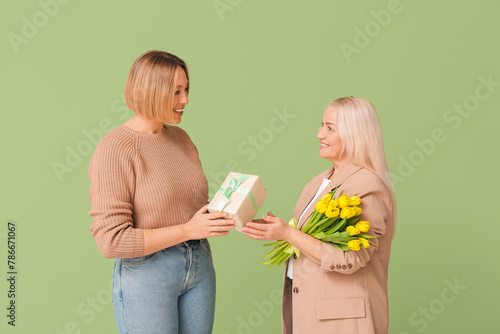 Adult woman greeting her mo...