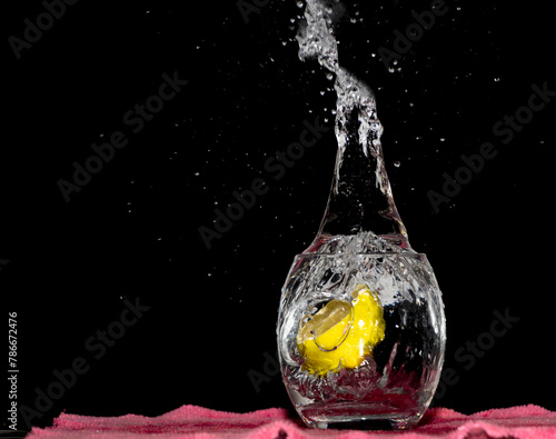 Falling Lime Into Clear Water. Splashing Water Outside, Dark Background
