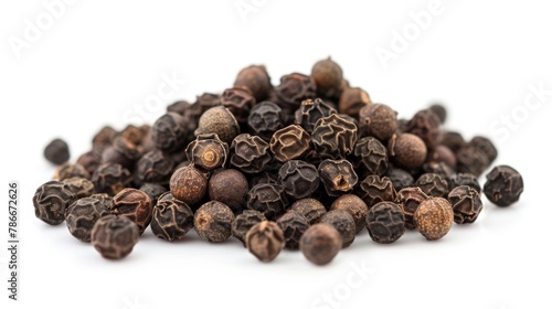A pile of black pepper seeds on a white surface. Suitable for culinary concepts