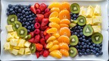 colorful fruit platter arranged in a rainbow pattern, with sections of sliced oranges, strawberries, blueberries, kiwi, and pineapple, ready for a family breakfast