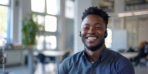 Communication and chat in office or workspace by black man with headset and smiling. African American tutor, webinar, and hot line operator consultant, company, and telemarketing.