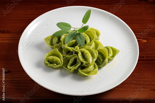 Dinner plate with green ravioli and sage