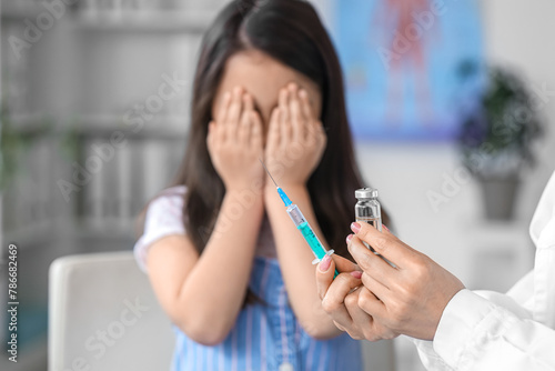 Doctor with syringe and amp...