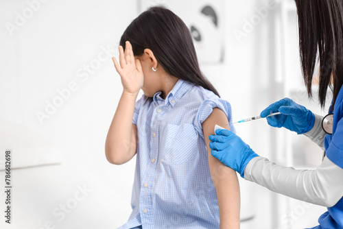 Scared little girl receivin...