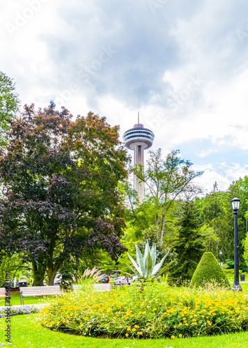 Lush park in Niagara Falls, Ontario, with vibrant flower beds and verdant trees, inviting relaxation and leisure in a picturesque Canadian landscape. High quality photo. ON, Canada