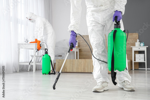 Male worker disinfecting fl...