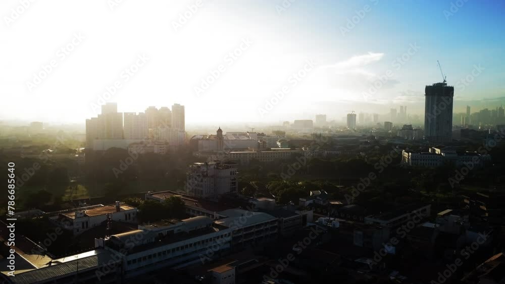 Aerial Scenic View Of Residential City Landscape Against Cloudy, Drone Flying Backwards During Sunset - Manila, Philippines Aerial Scenic View Of Residential City Landscape Against Cloudy, Drone Flying Backwards During Sunset - Manila, Philippines