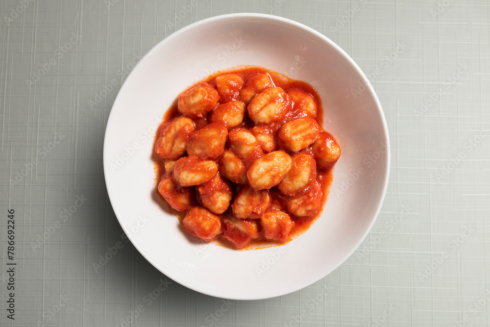White bowl with tomato potato dumpling White bowl with tomato potato dumpling